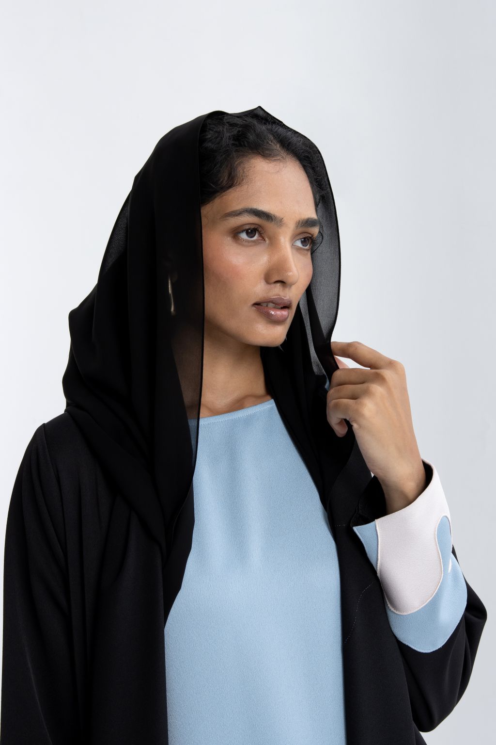 Elegant black and blue abaya featuring a stylish design and a flowing silhouette