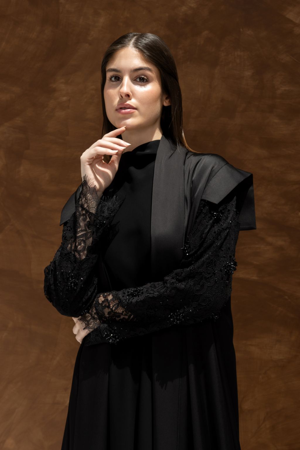 Elegant black evening dress with lace sleeves and stylish cape design for formal occasions