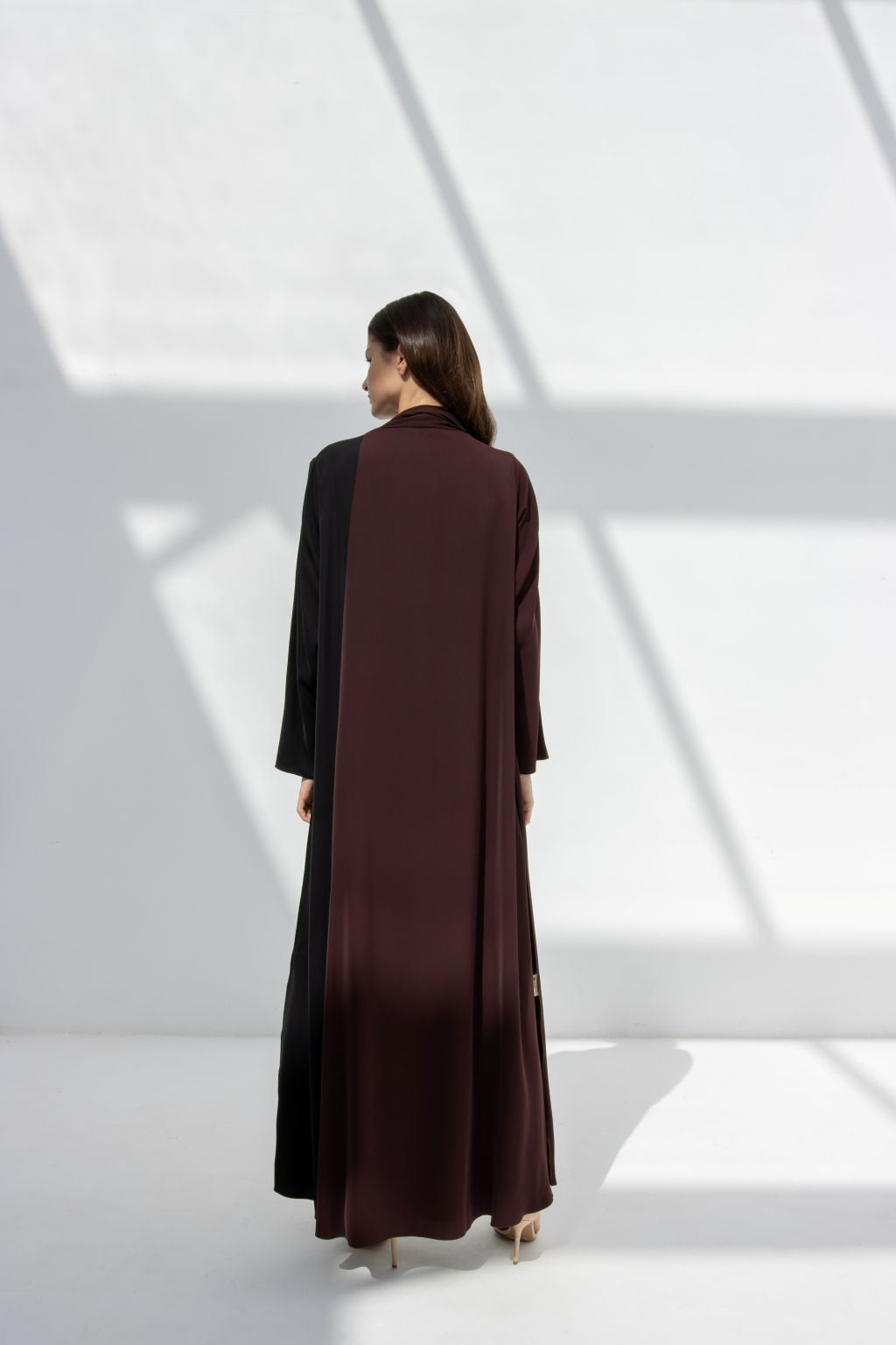 Back view of elegant half moon dress abaya by Selected Lines in black and brown with long sleeves
