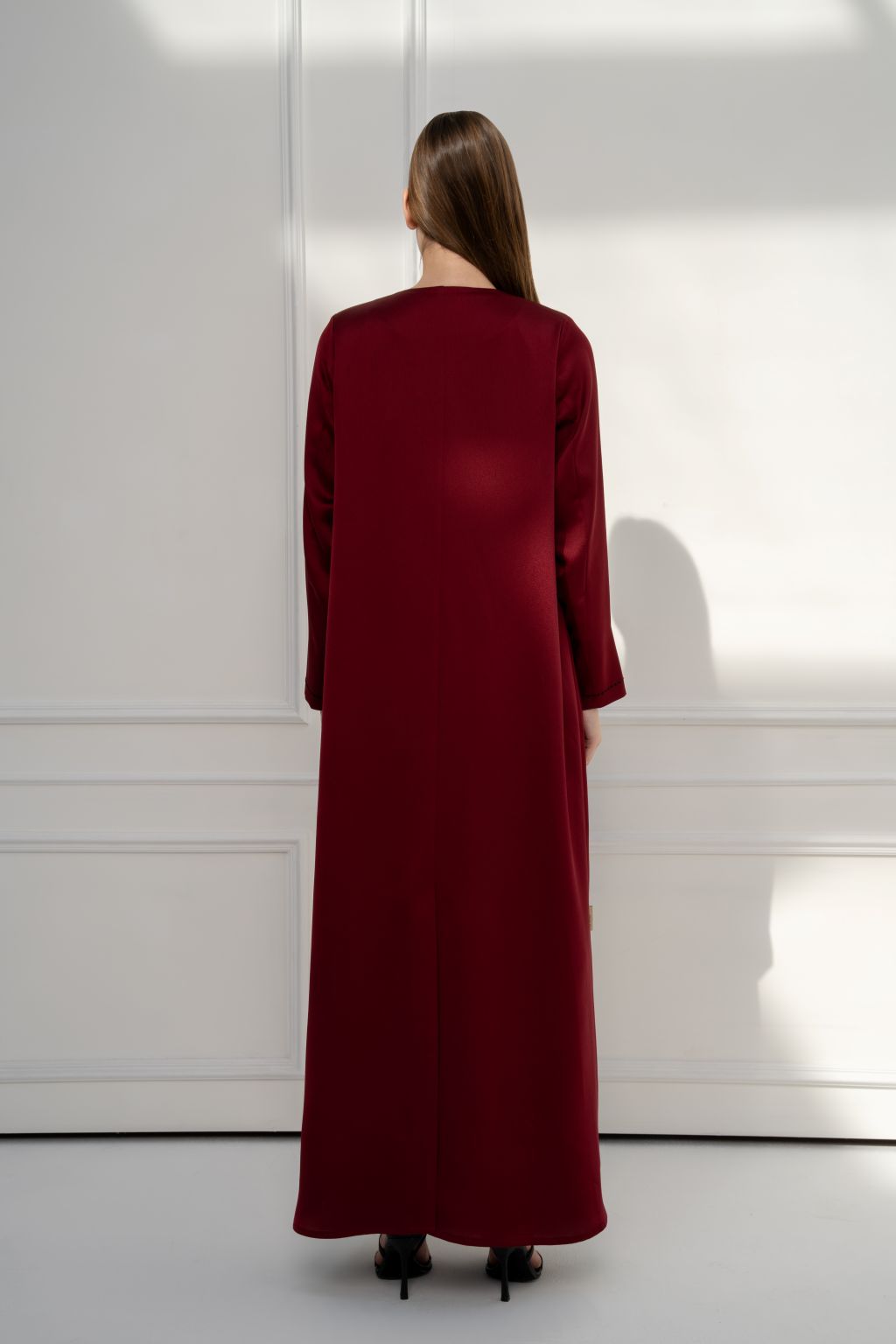 Selected Lines burgundy abaya with long sleeves, designed as an elegant modest evening dress