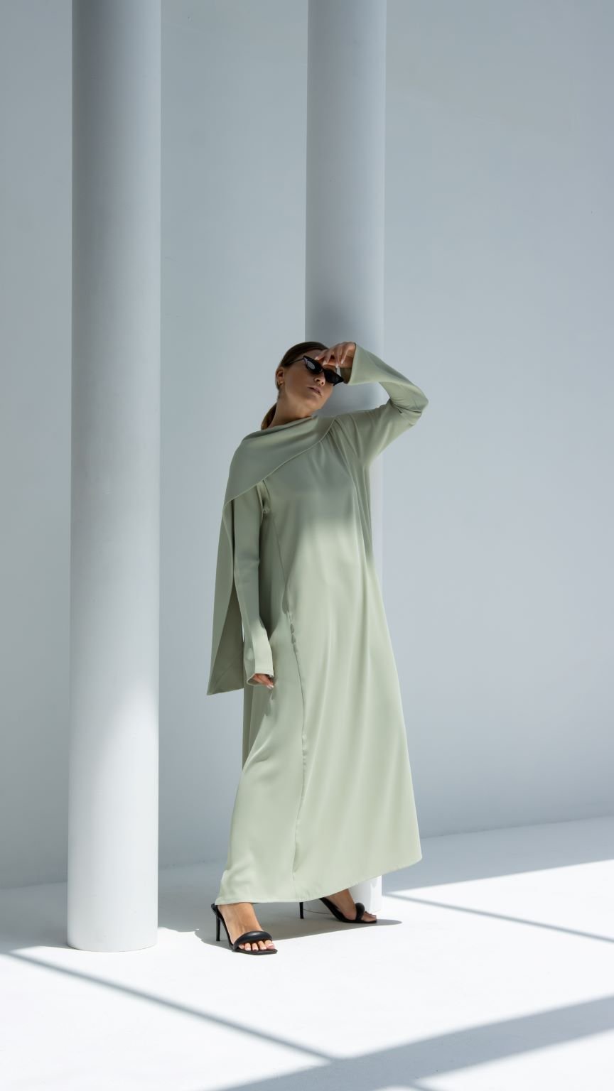 Elegant scarf dress in light green with long sleeves, styled for a chic look