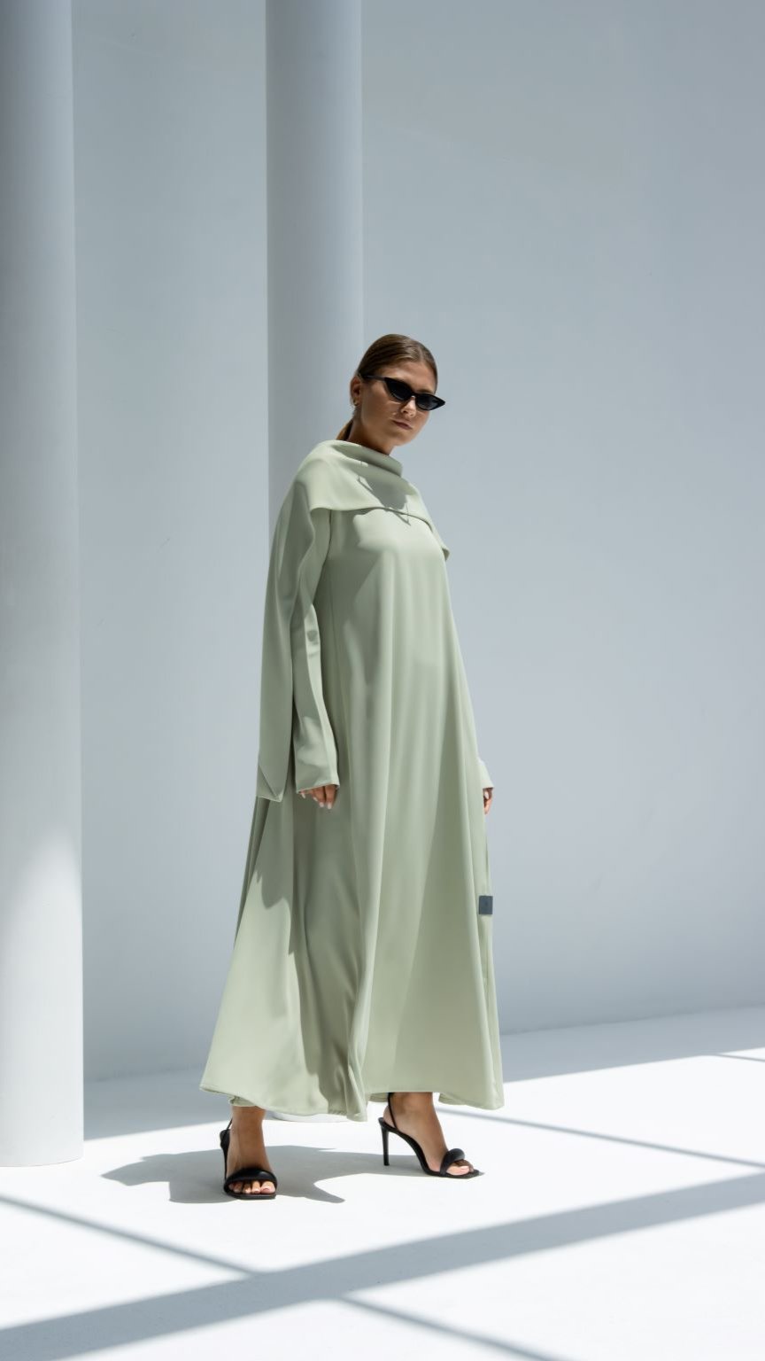 Elegant scarf dress in light green, styled with sunglasses and high heels for a chic look