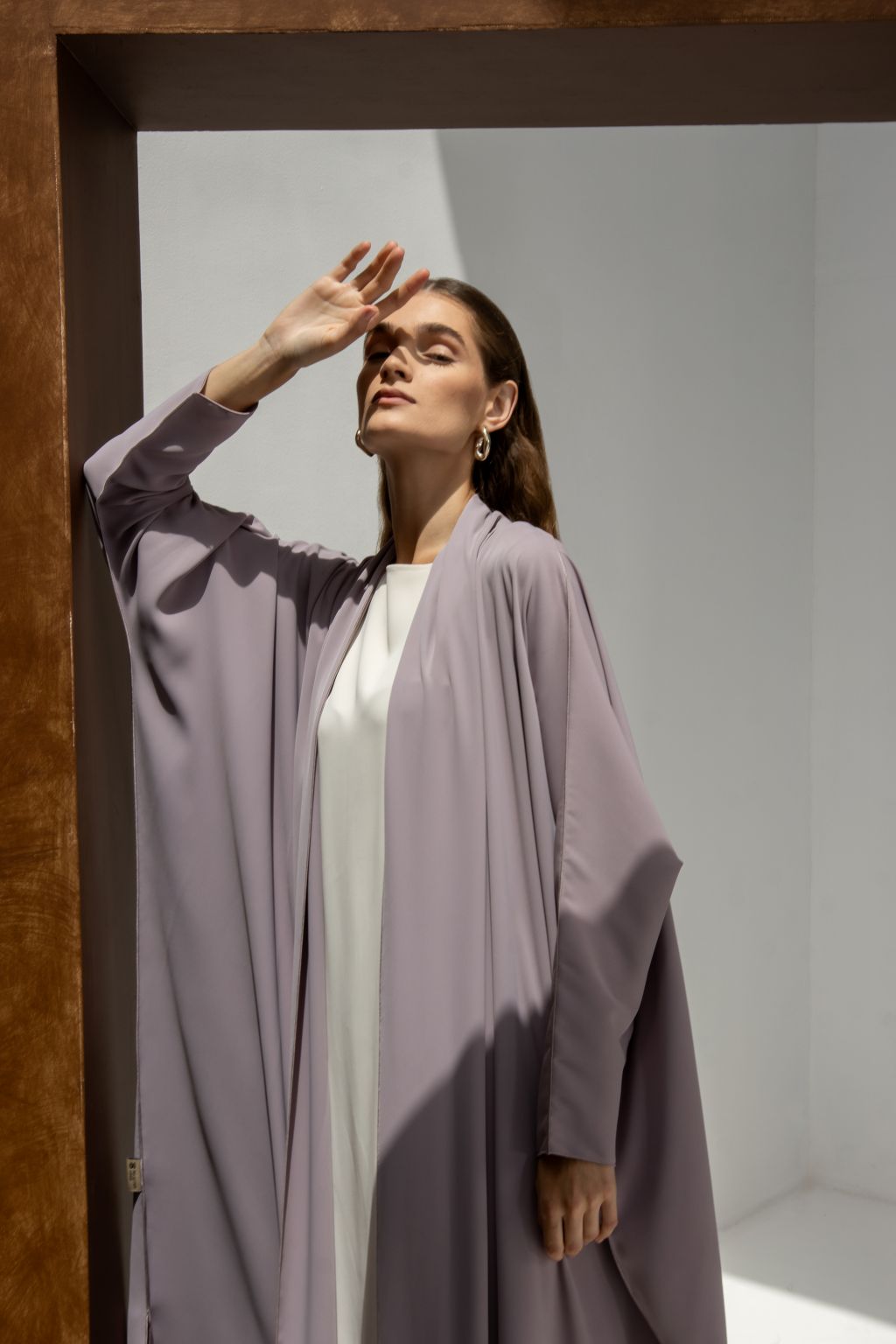Selected Lines elegant signature abaya in soft lavender worn by woman in bright minimalist setting