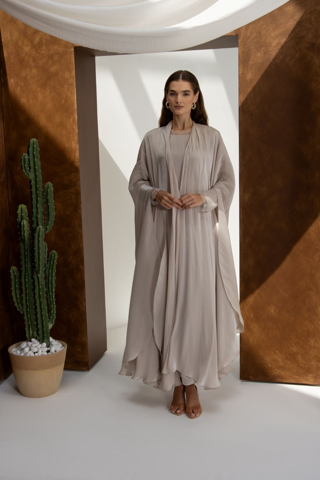 Elegant Swan Flow abaya by Selected Lines in soft beige worn by model with long sleeves and flowing fabric