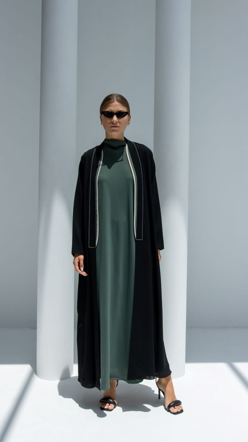 Elegant two lines abaya in black with contrasting trim, perfect for stylish occasions