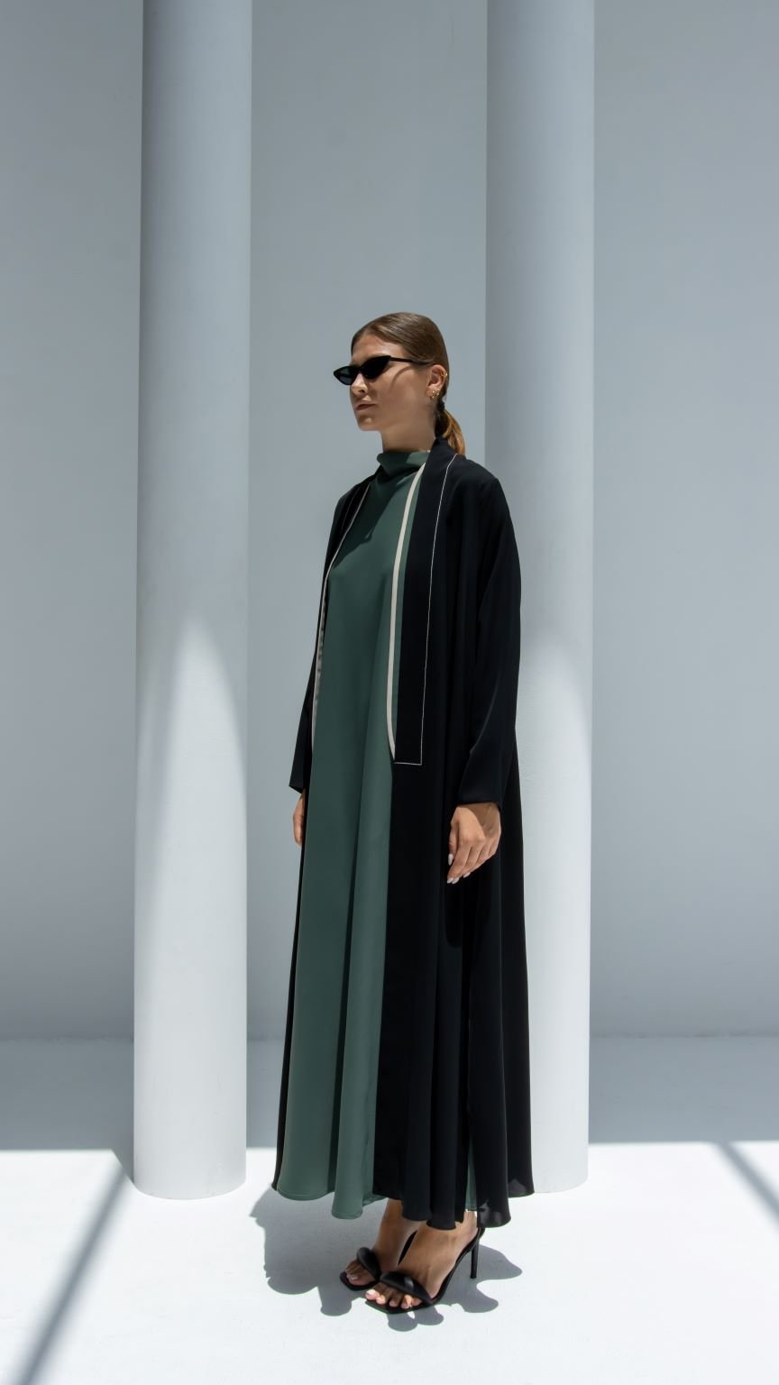 Elegant two lines abaya in black and green fabric, perfect for stylish occasions