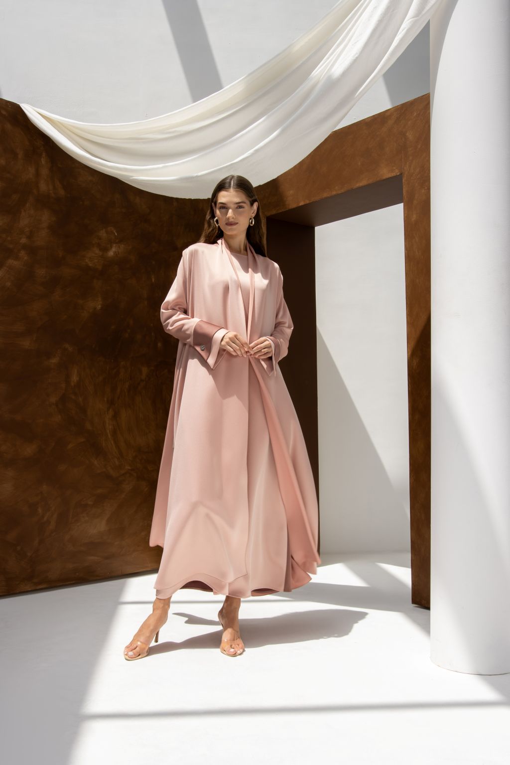 Selected Lines high quality formal abaya in soft pink worn by model in bright minimal setting