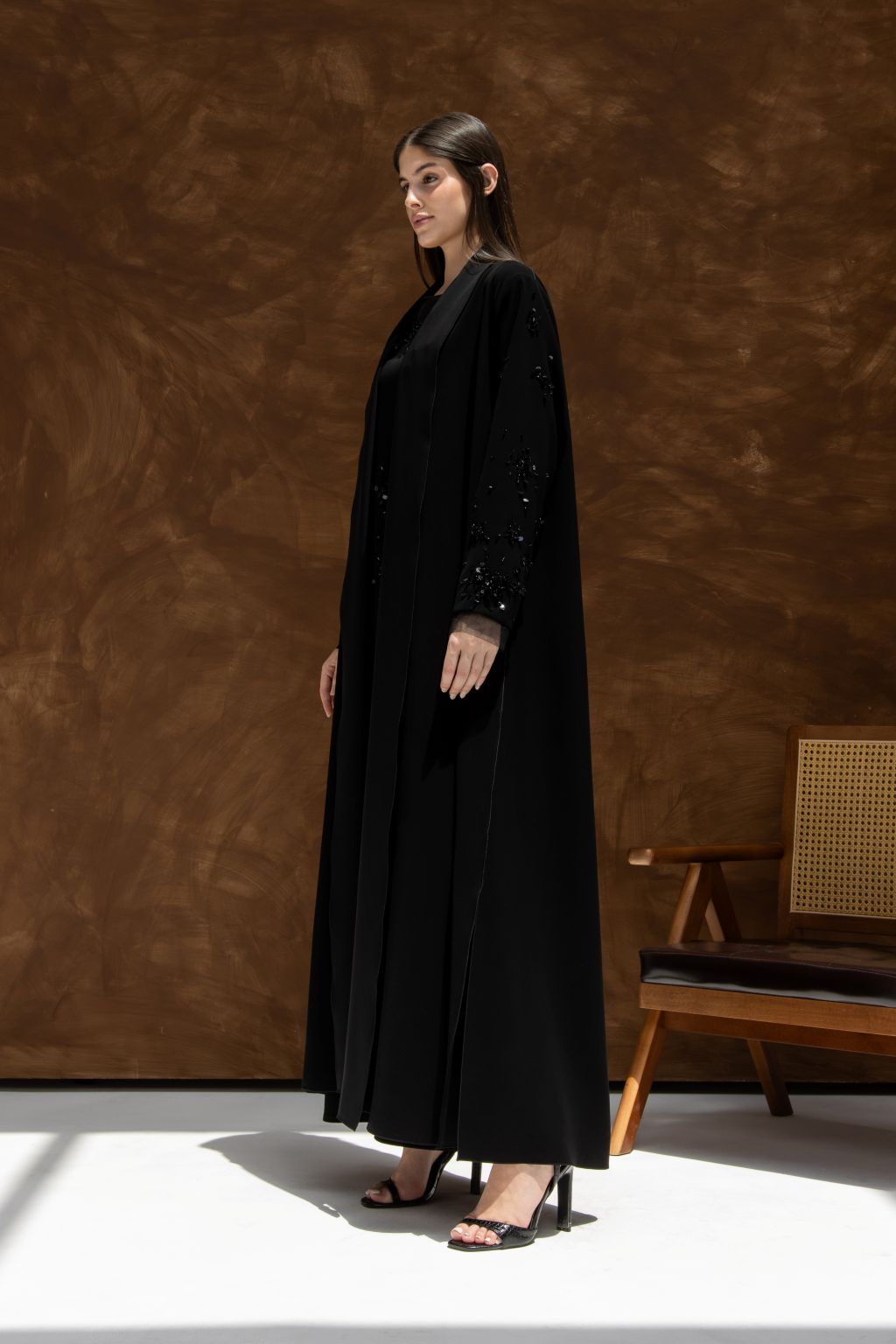 Selected Lines La Lueur abaya Set in black with detailed sleeves worn by model with black heels