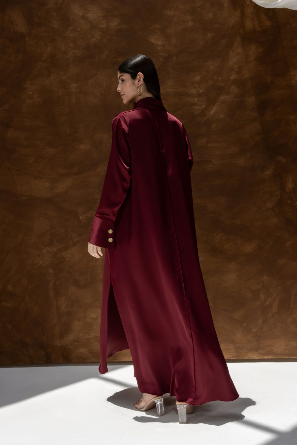 Selected Lines luxury abaya dress for women in deep burgundy with long sleeves and gold buttons