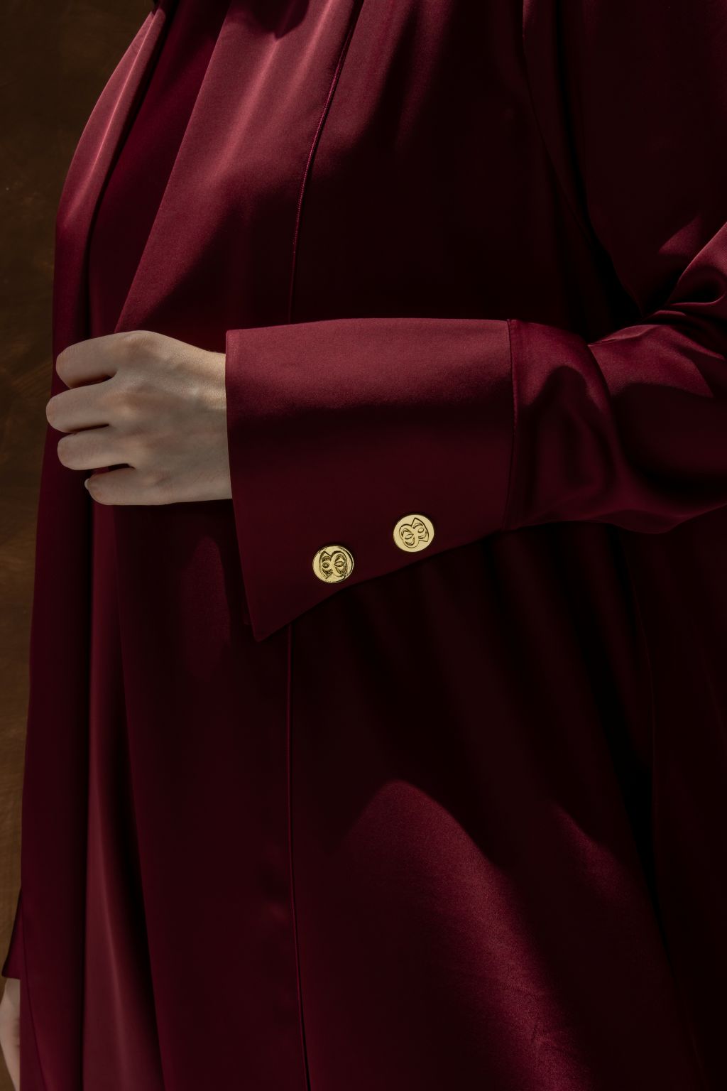 Selected Lines luxury abaya dress for women in deep burgundy with gold button details on sleeve cuff