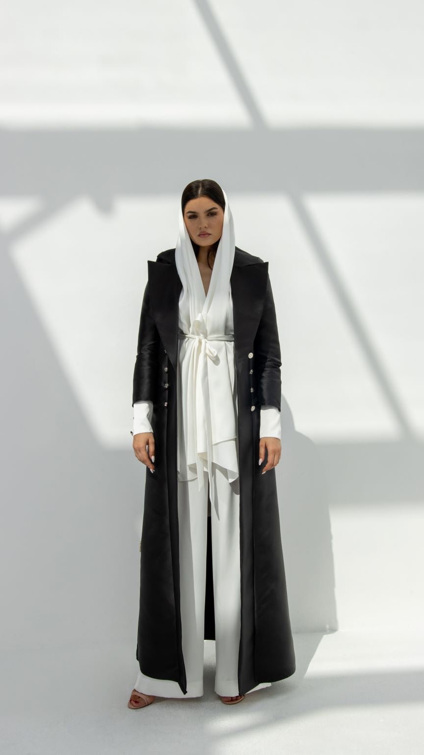 Elegant luxury black abaya for women featuring a stylish design with a waist tie and long sleeves