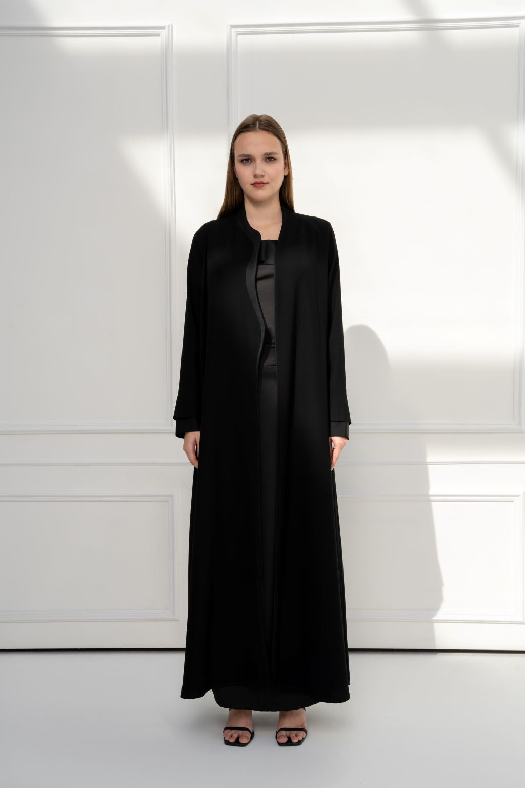 Selected Lines luxury black abaya featuring a sleek design with long sleeves and an elegant silhouette