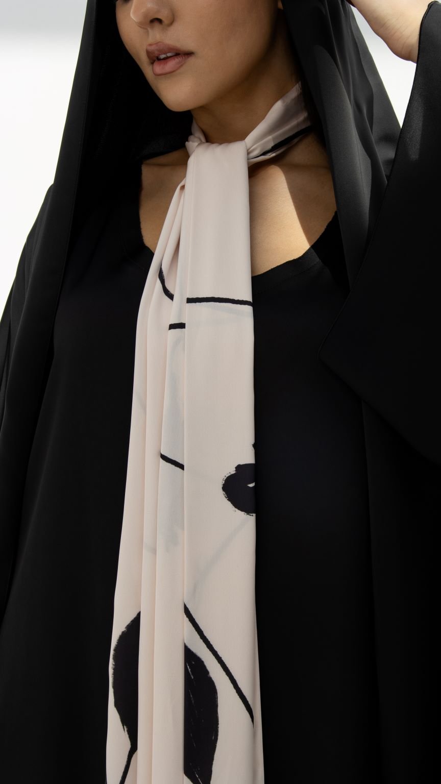 Elegant model wearing a luxury black hoodie abaya with a stylish scarf for modern fashion.