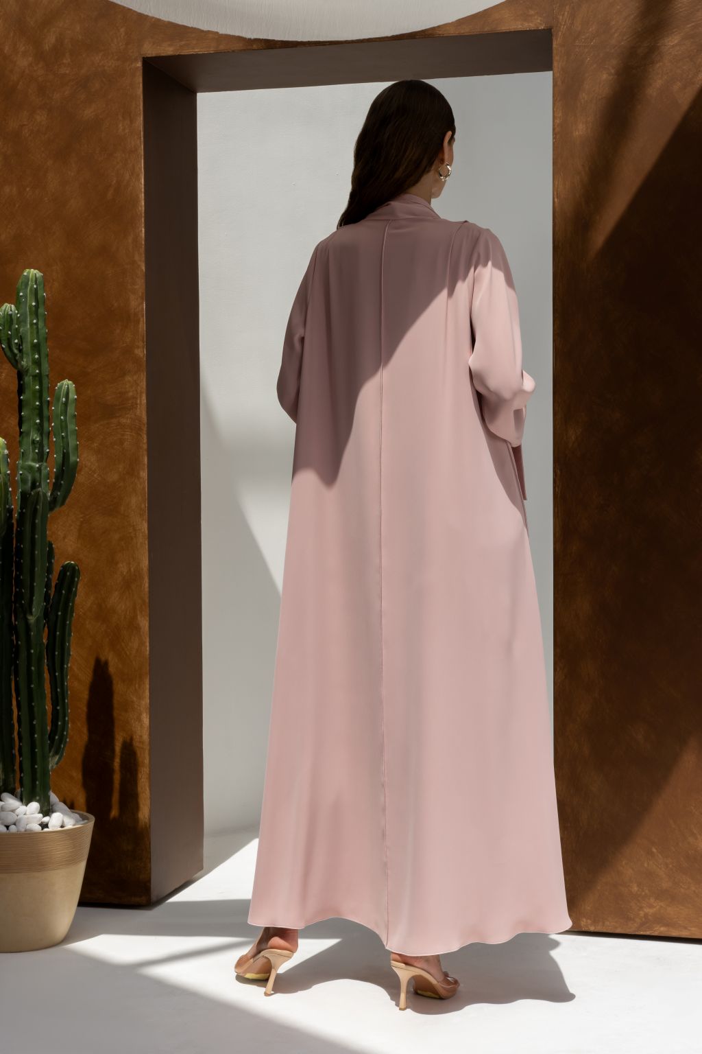 Selected Lines luxury buttoned abaya in soft pink with long sleeves and flowy design shown from back