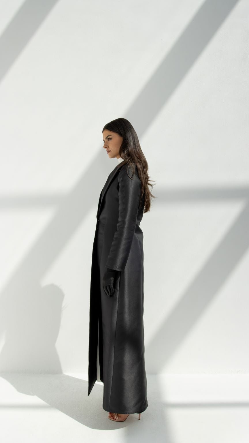 Selected Lines luxury coat abaya in black worn by woman standing in natural light