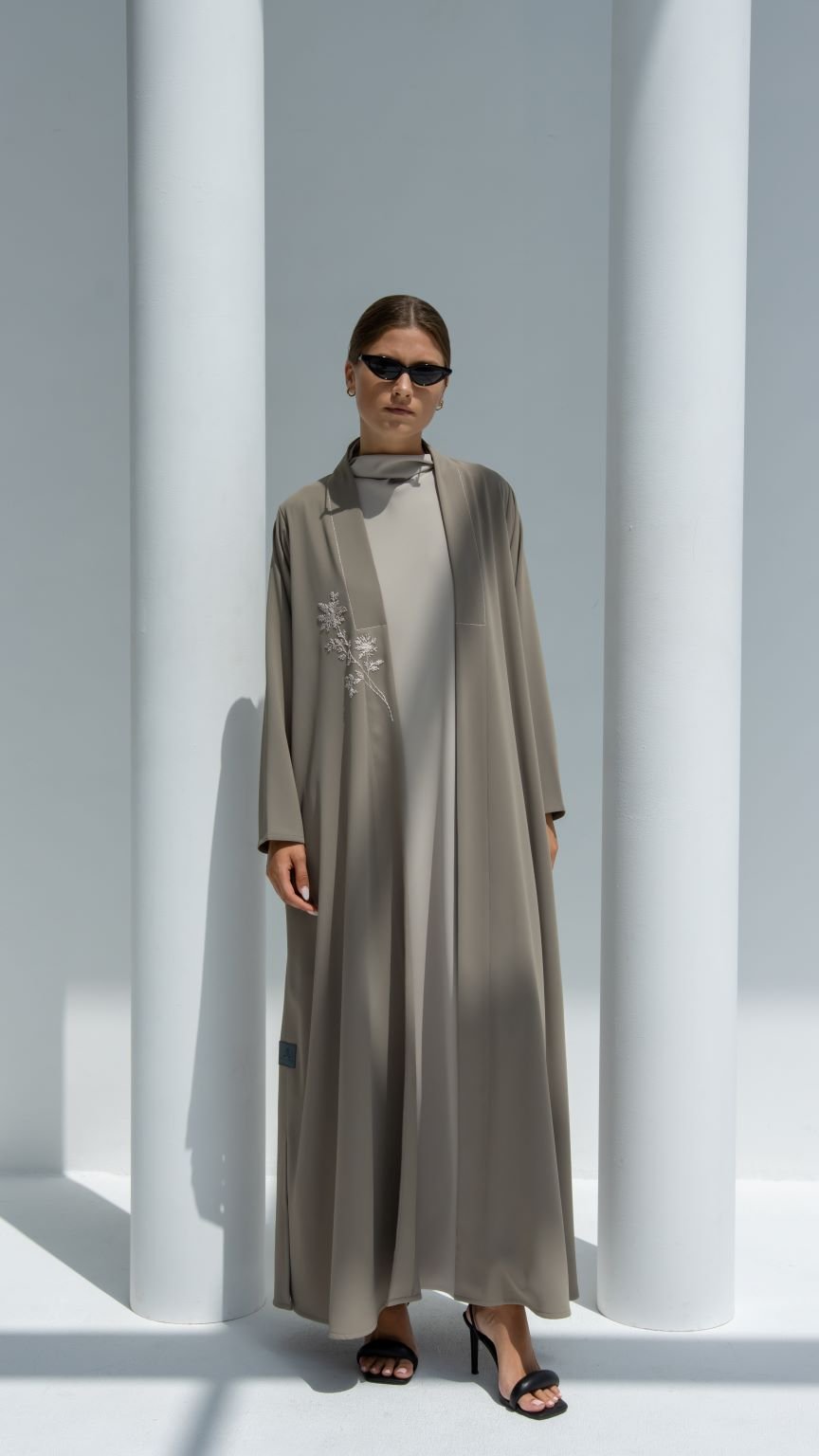 Selected Lines luxury floral threadwork abaya in taupe shade worn with black heels and sunglasses