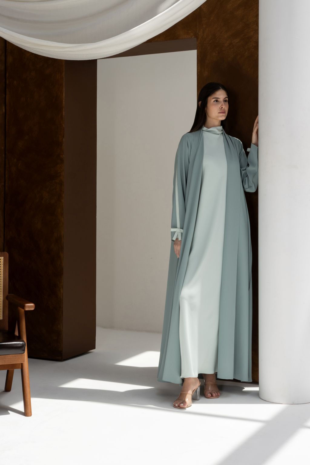 Selected Lines luxury modest Fionka Belle abaya in light blue with white inner dress worn by woman indoors
