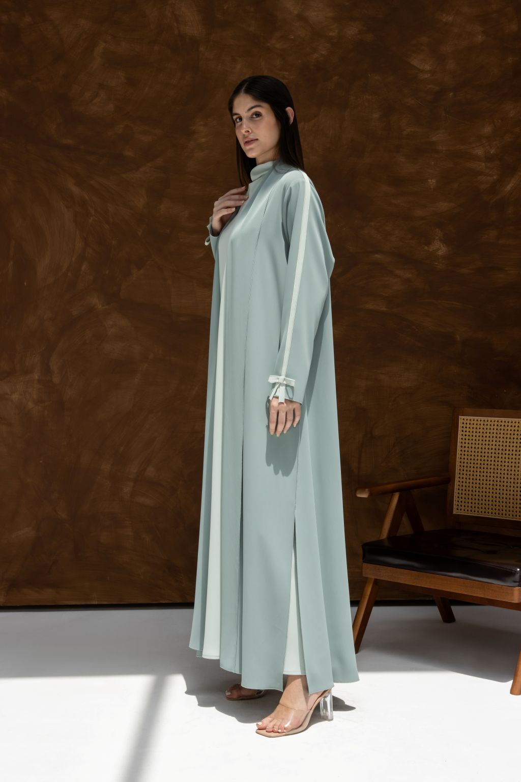 Selected Lines luxury modest Fionka Belle abaya in light blue worn by woman with long sleeves and high neckline