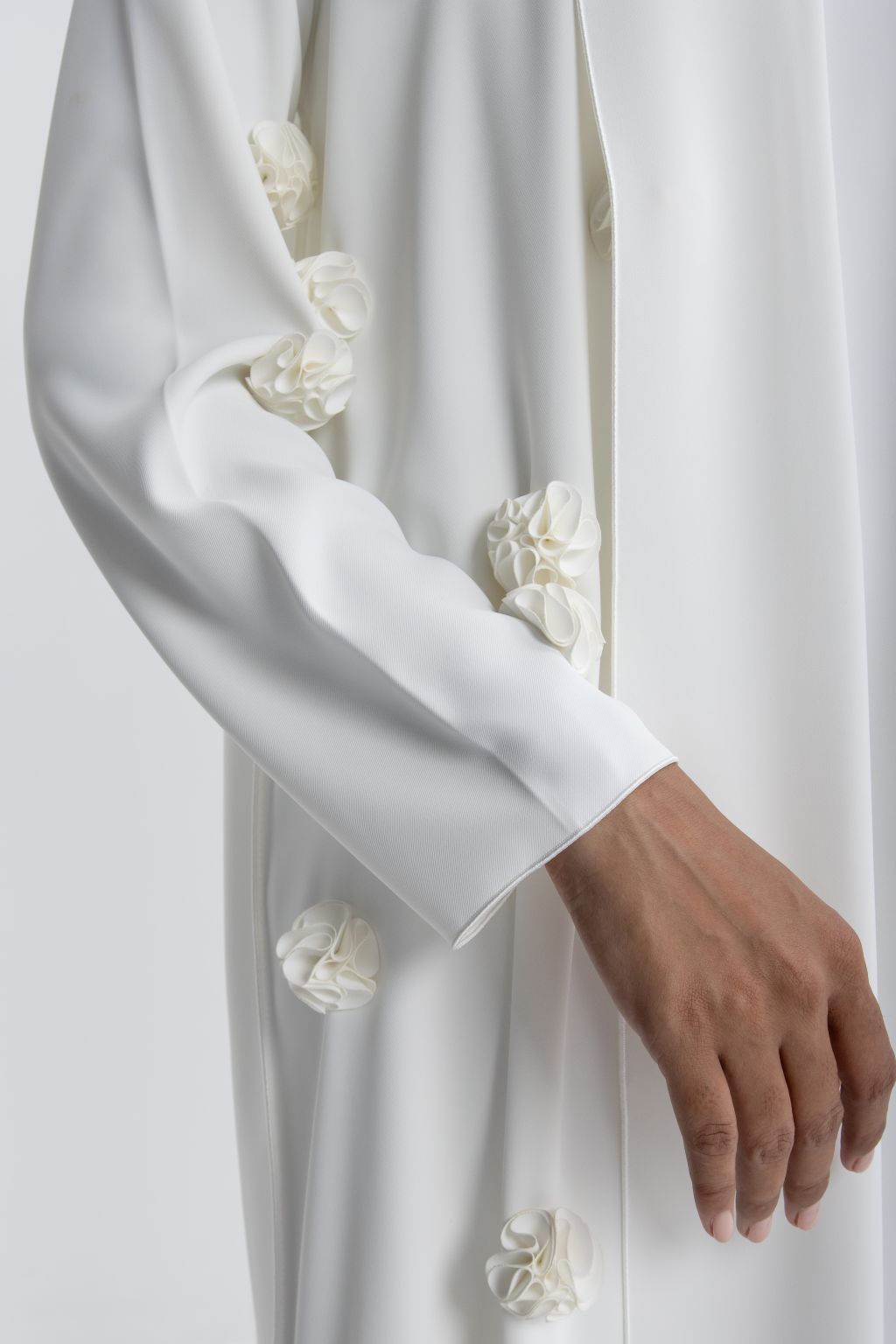 Luxury white abaya with rose embroidery featuring elegant floral accents on sleeves