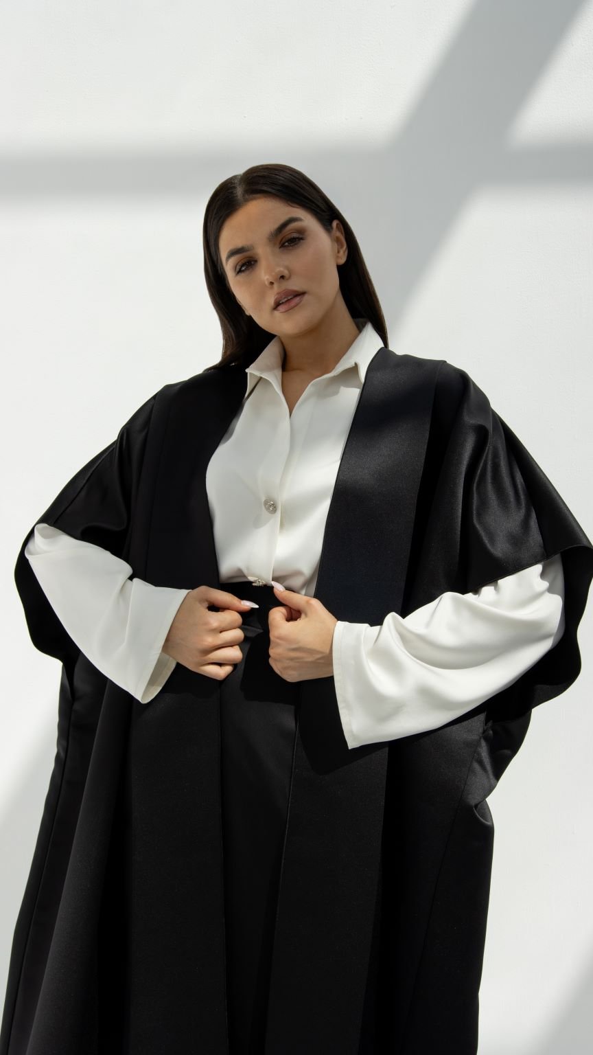 Selected Lines luxury yoga abaya in black worn over white blouse for a modern modest look