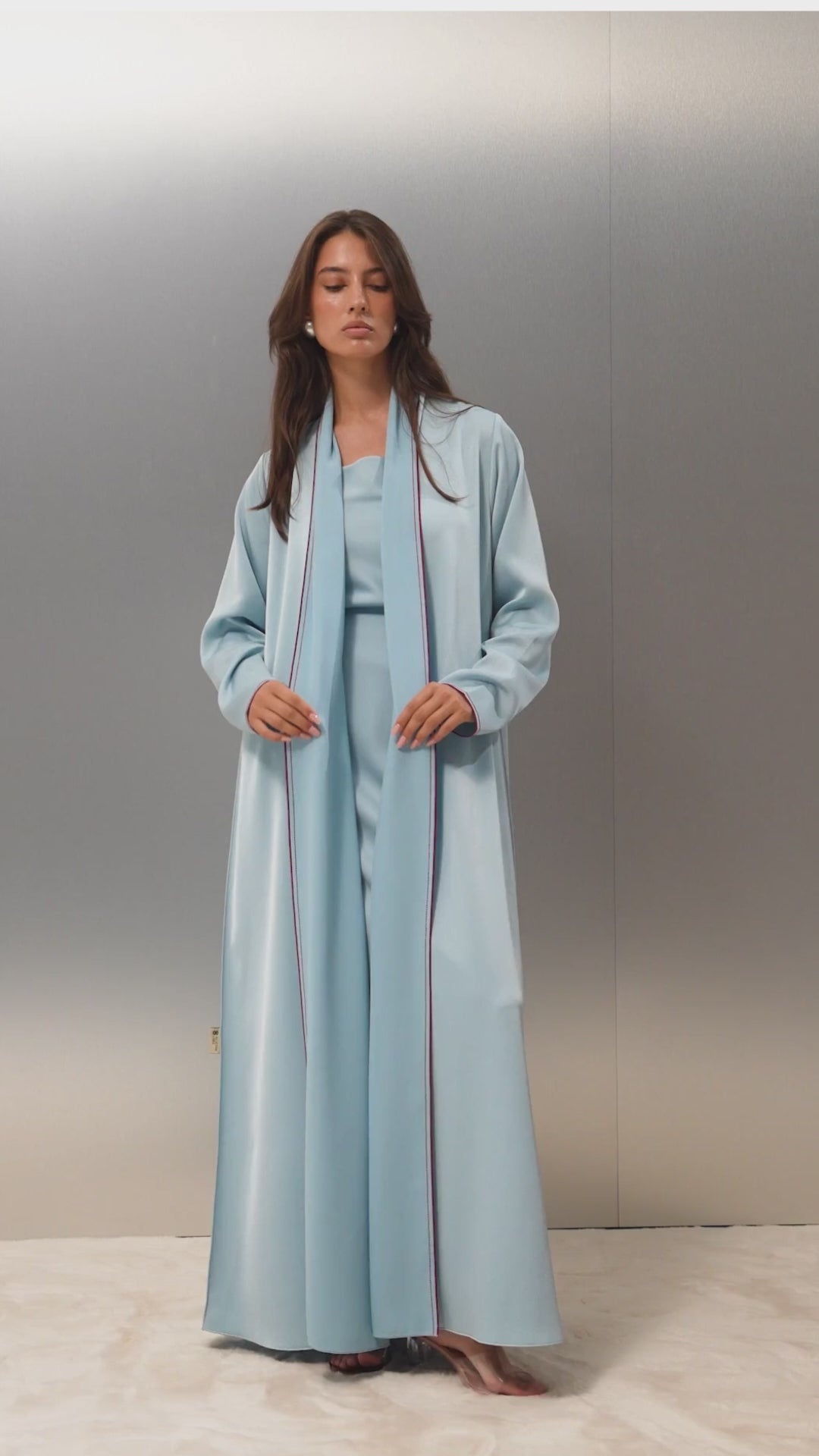 Video of the Sapphire abaya by Selected Lines — baby blue shiny crepe with red pico line work detailing