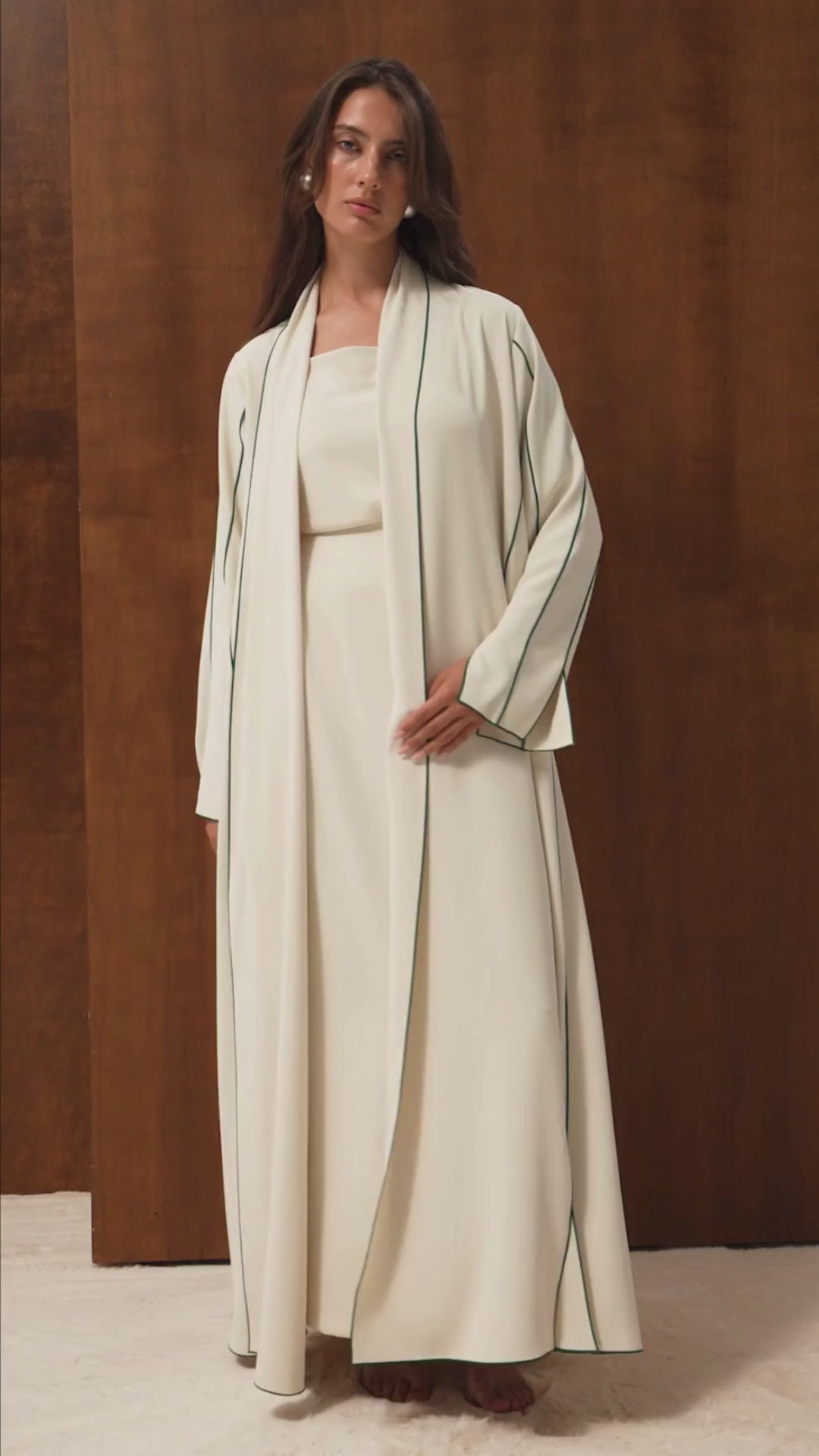 Video of the Avery abaya by Selected Lines — off-white Japanese crepe with a green pico line border, cut A-line