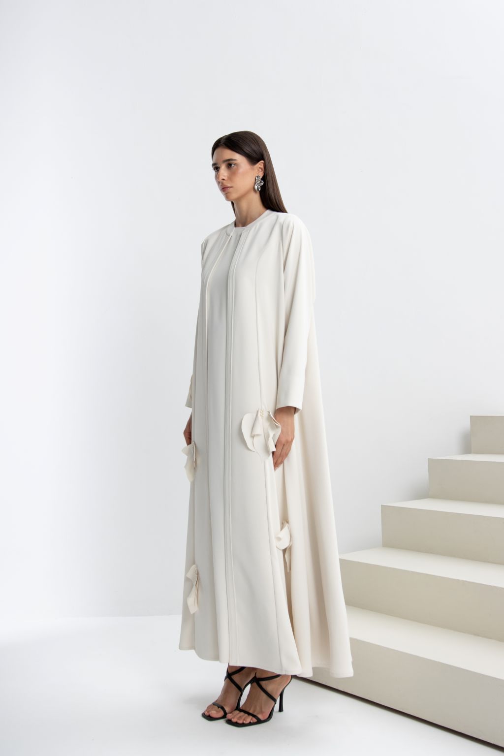 Elegant and stylish refined luxury evening abaya in cream with floral details and loose fit