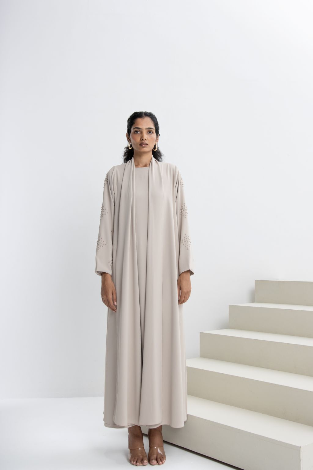 Refined neutral evening abaya with elegant sleeves and flowing silhouette for stylish occasions
