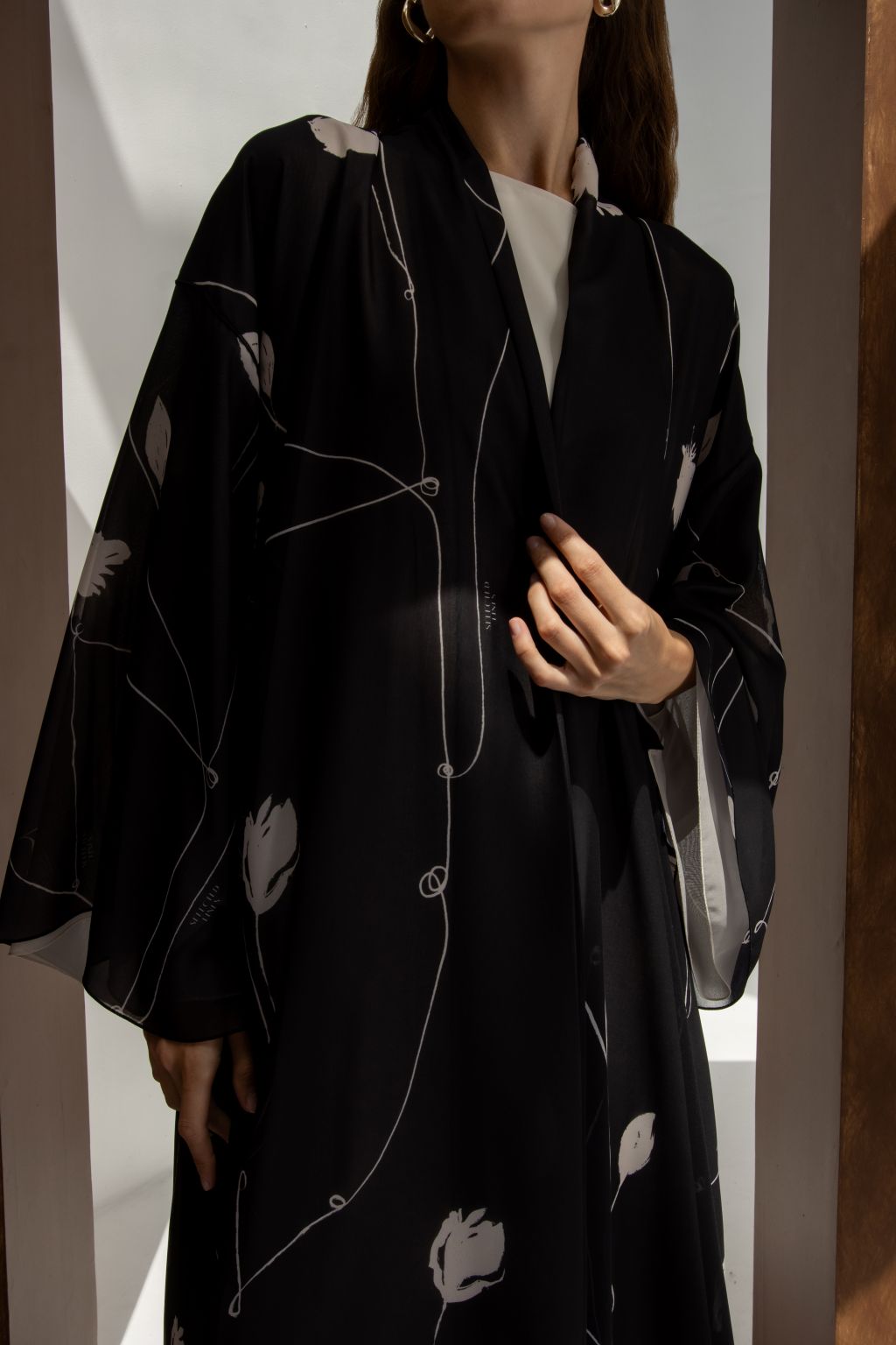Selected Lines signature leaves black abaya with elegant white leaf patterns and flowing sleeves