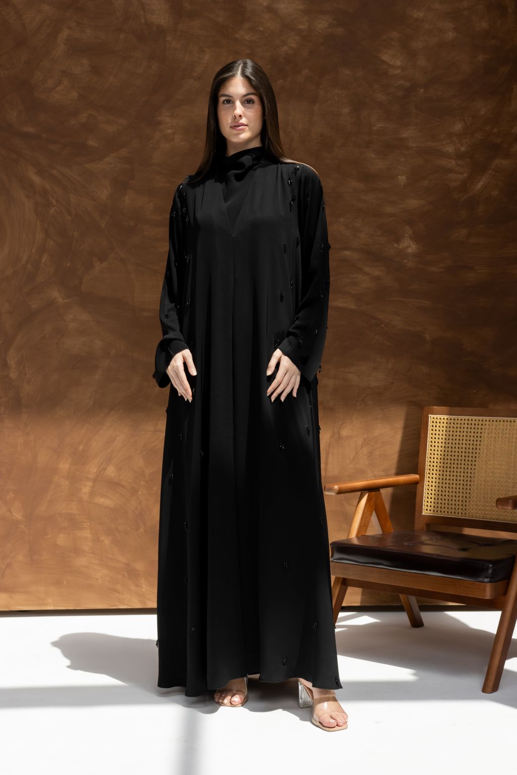 Selected Lines timeless black abaya gown with long sleeves and high neckline worn by model