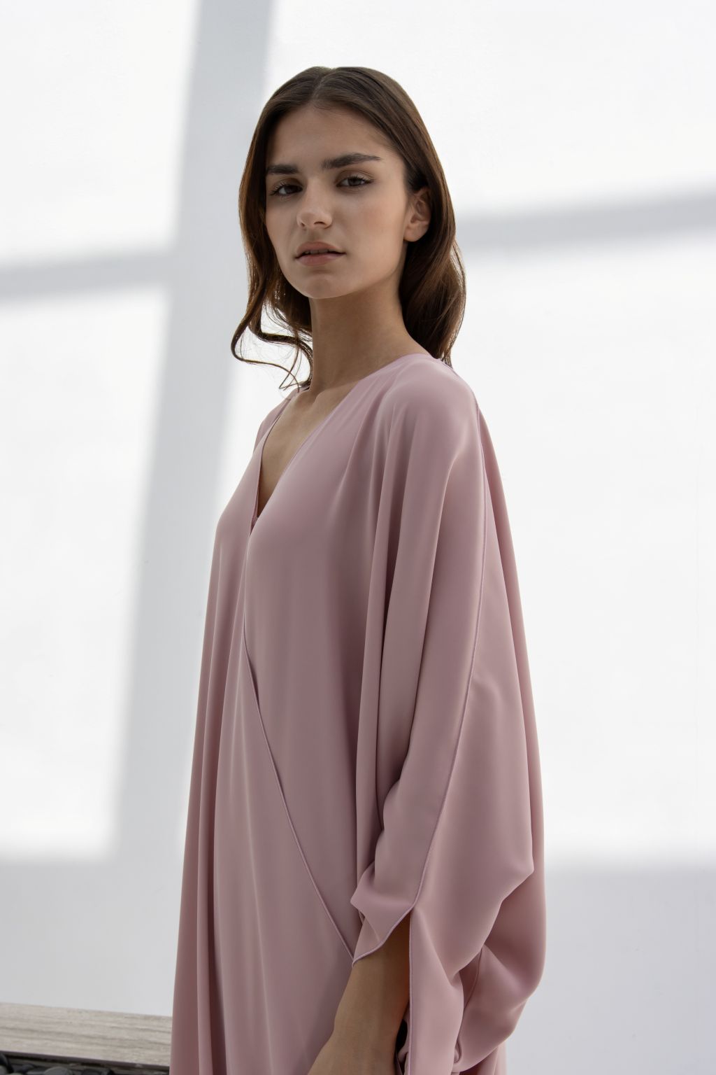 Selected Lines timeless designer evening gown in soft pink with a flowing silhouette and V-neck design