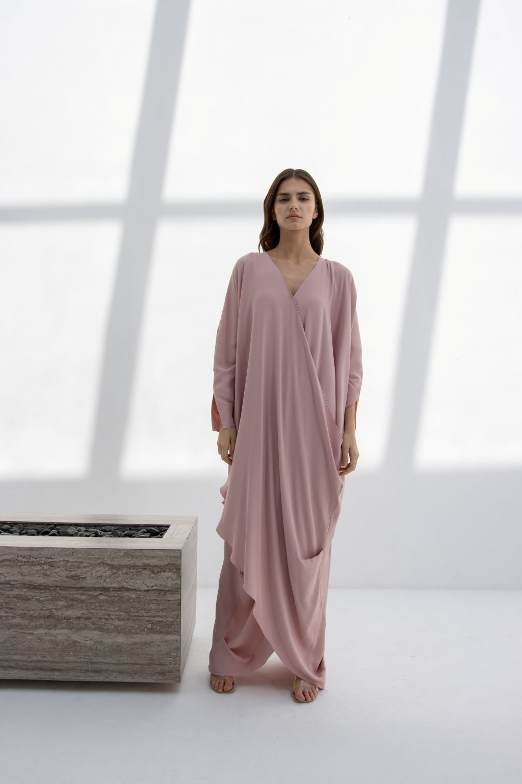 Selected Lines timeless designer evening gown in soft pink with a flowing drape and V-neck design