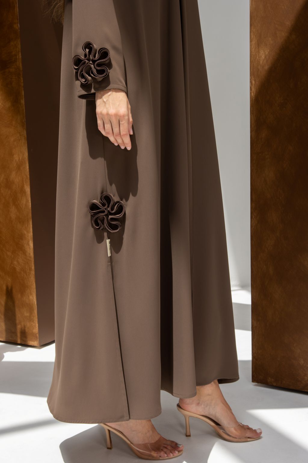 Selected Lines brown abaya with floral details on sleeves and slit showcasing timeless modest evening wear