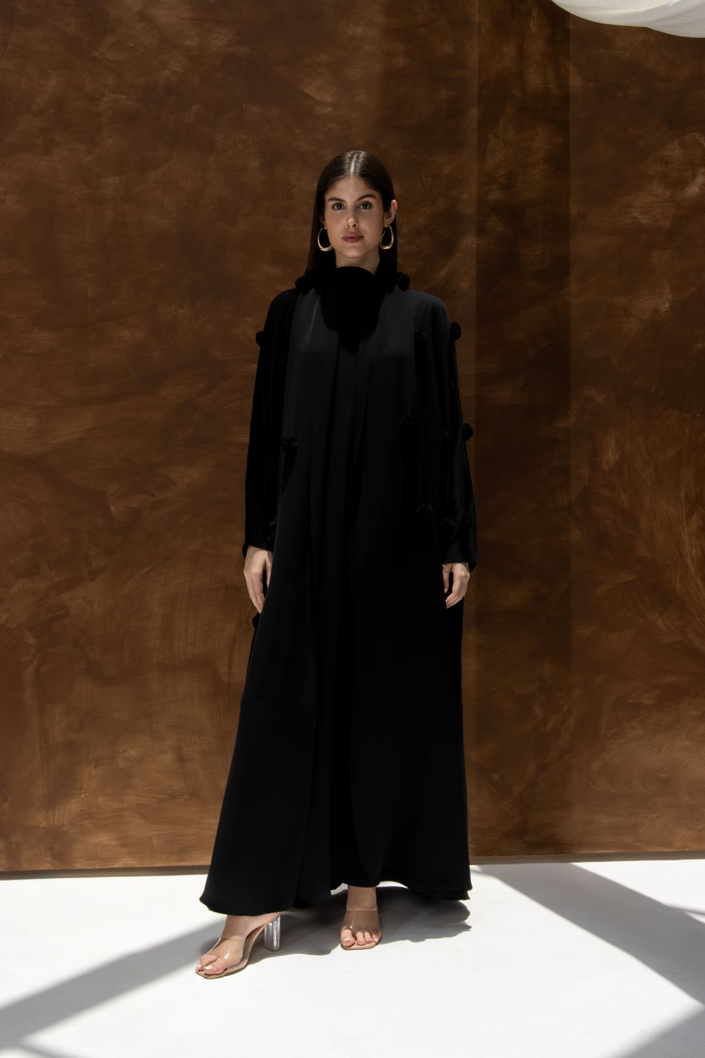 Selected Lines black Blooming Bahraini abaya elegant design worn by woman with long sleeves and full length